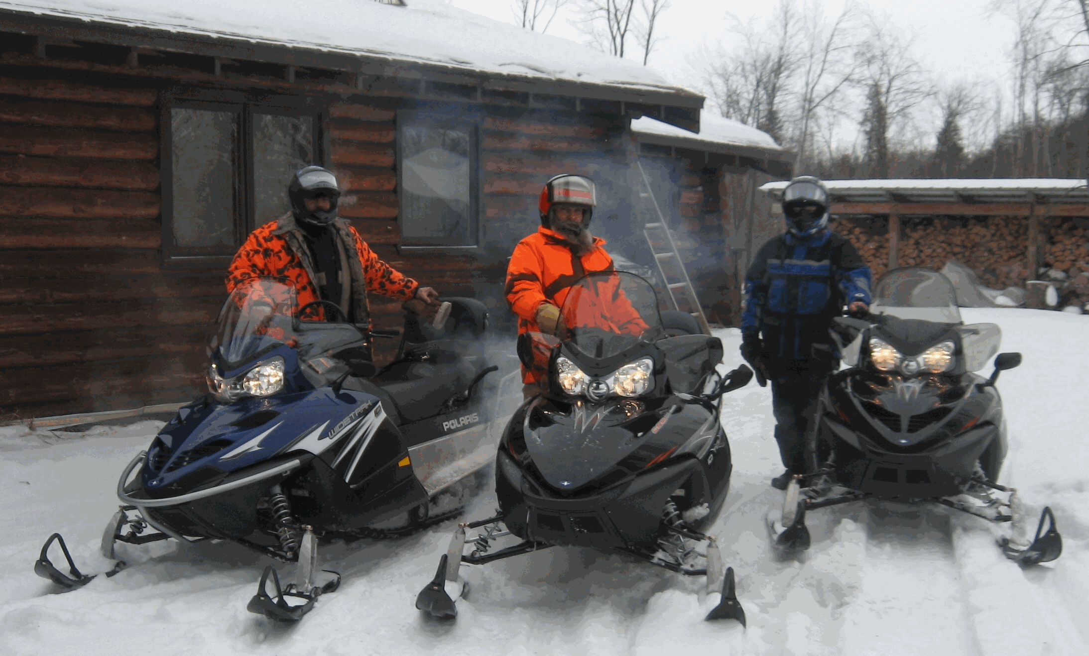 three snowmobilers